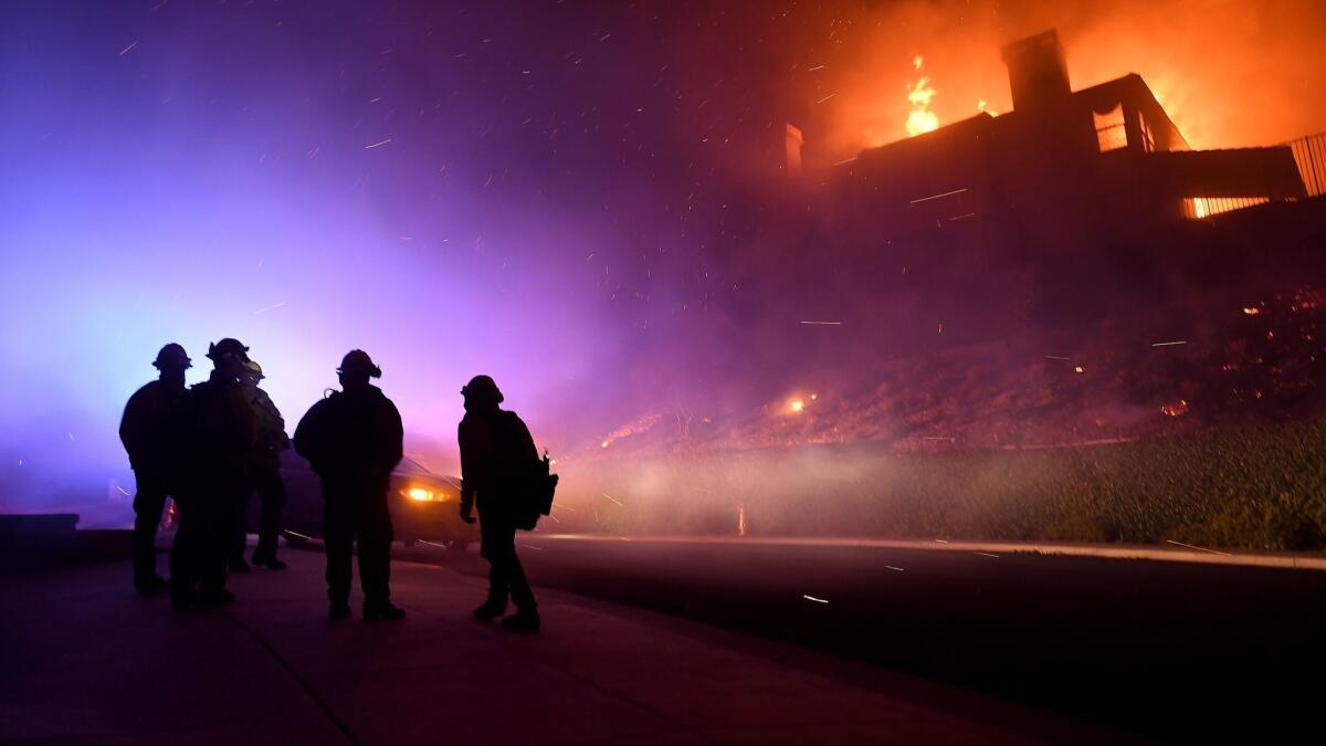Firefighters at a house fire on Los Feliz Drive in Thousand Oaks early Friday.