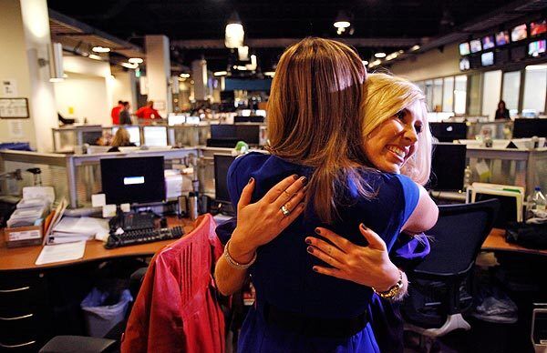 Branson, right, receives a hug from fellow KCBS reporter Lisa Sigell as she makes her way through the newsroom. Branson said she knew something was terribly wrong when she began her live report from the Grammys. See full story