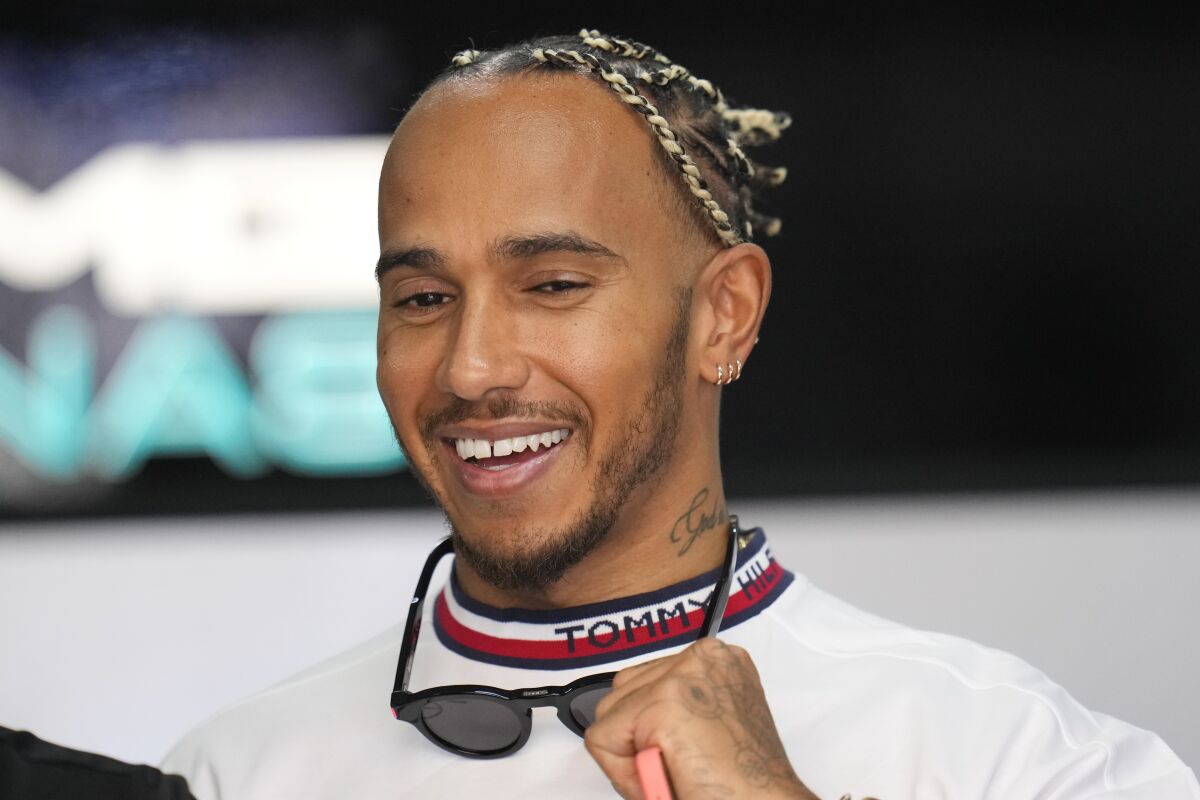 Mercedes driver Lewis Hamilton, of Britain, smiles at pit prior to the start of the first practice for the French Formula One Grand Prix at Paul Ricard racetrack in Le Castellet, southern France, Friday, July 22, 2022. The French Grand Prix will be held on Sunday. (AP Photo/Manu Fernandez)