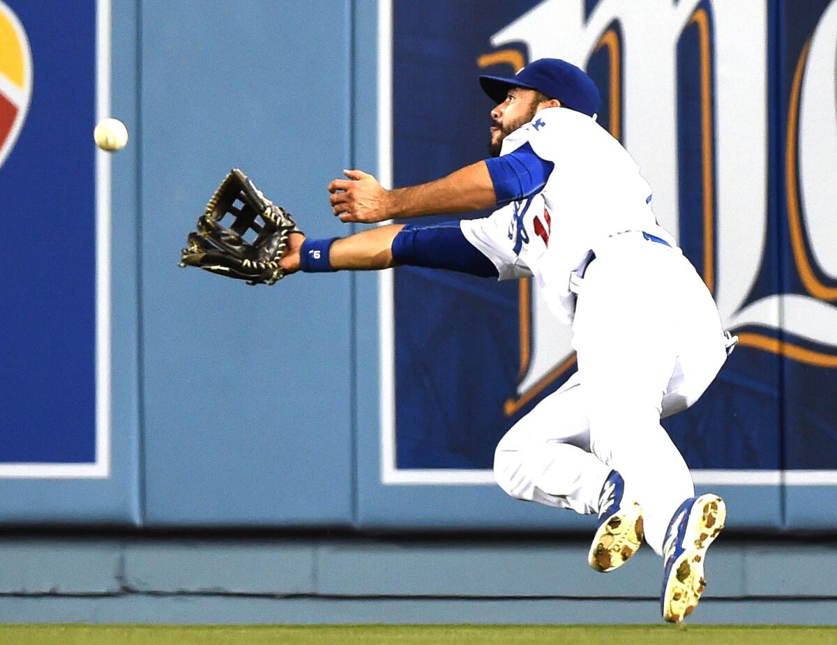Dodgers right fielder Andre Ethier dives to make a catch on a deep fly ball hit by Giants second baseman Joe Panik in the second inning Wednesday night.