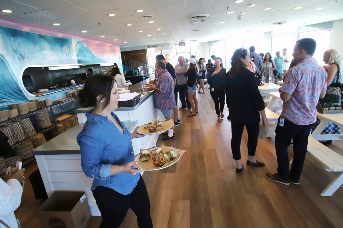 Guests enjoy appetizers at Bud & Gene's restaurant during its grand opening ribbon-cutting event Tuesday.