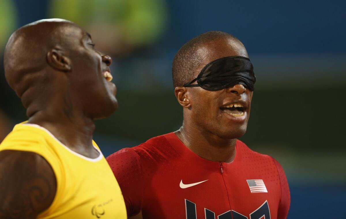 David Brown, right, and guide Jerome Avery, share a smile after a win last Thursday in Doha, Qatar.