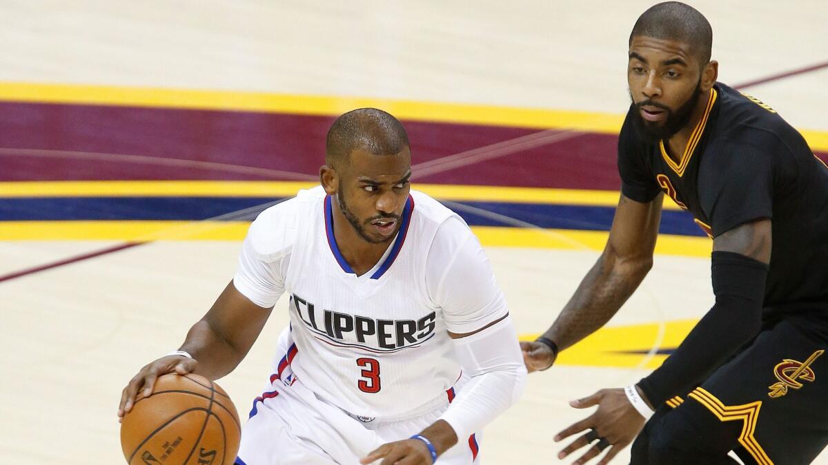 Clippers' Chris Paul drives around Cleveland's Kyrie Irving on Thursday.