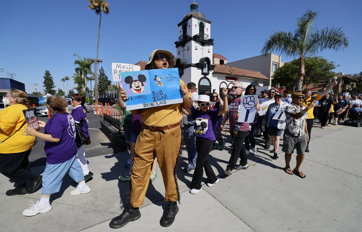Union members march on Harbor Boulevard for a new contract that they approved on Monday