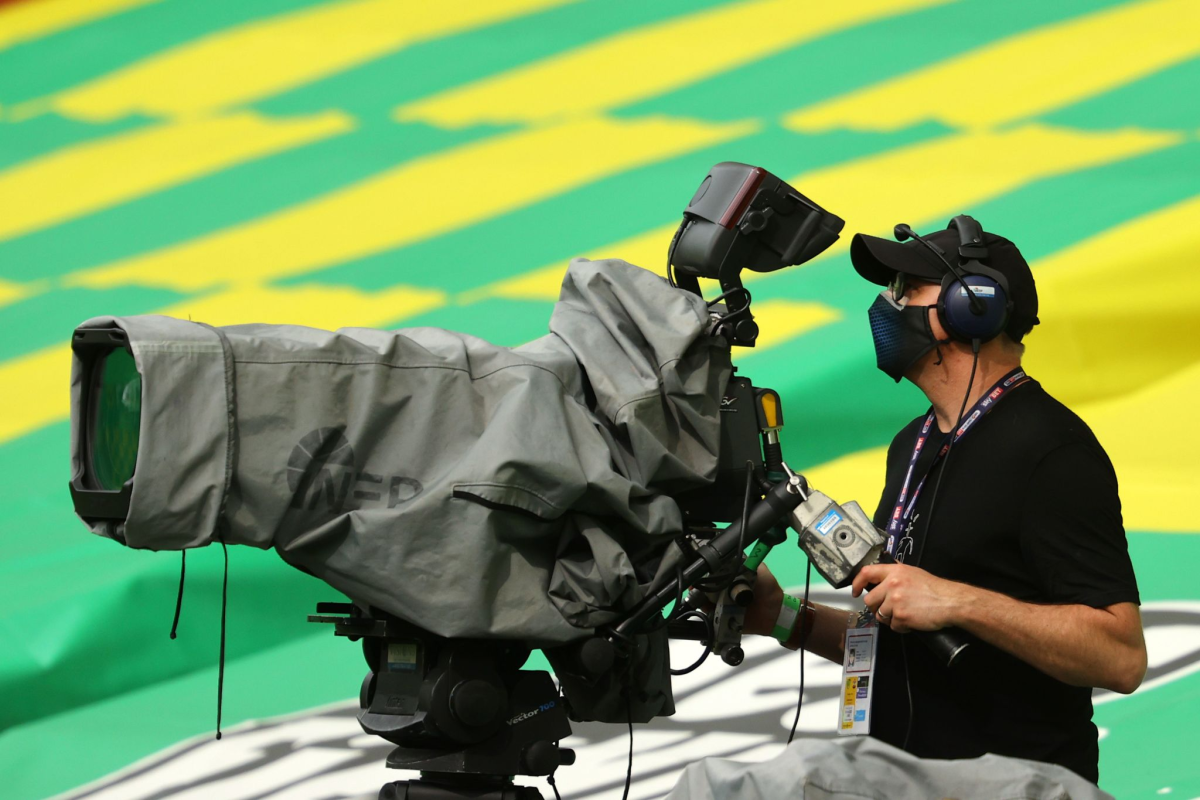 A television camera operator is seen ahead of an English Premier League match.