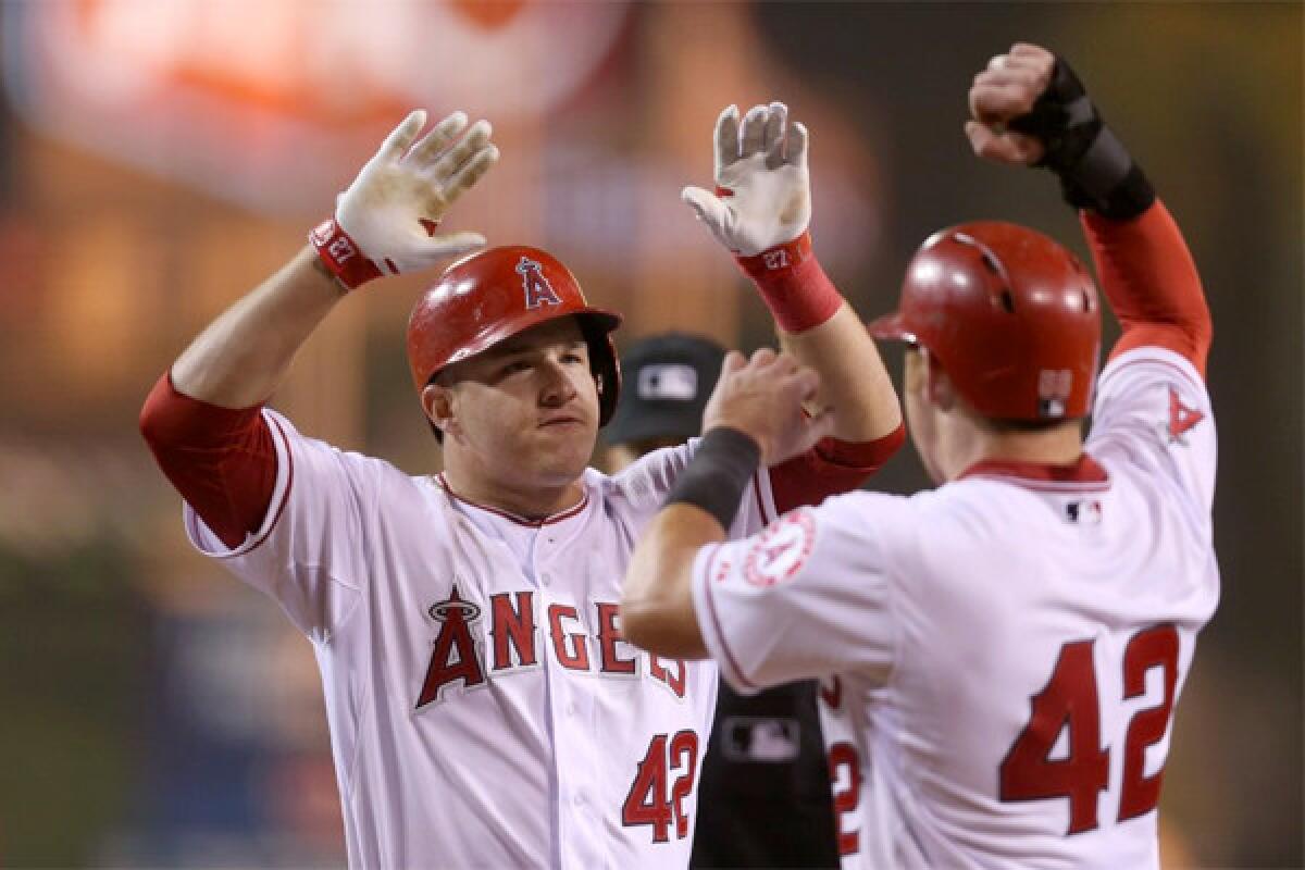 Mike Trout celebrates after hitting a two-run game-tying blast in the bottom of the ninth inning Tuesday to force extra innings with the Oakland Athletics. The Angels lost to the Athletics, 10-9, in 11 innings.