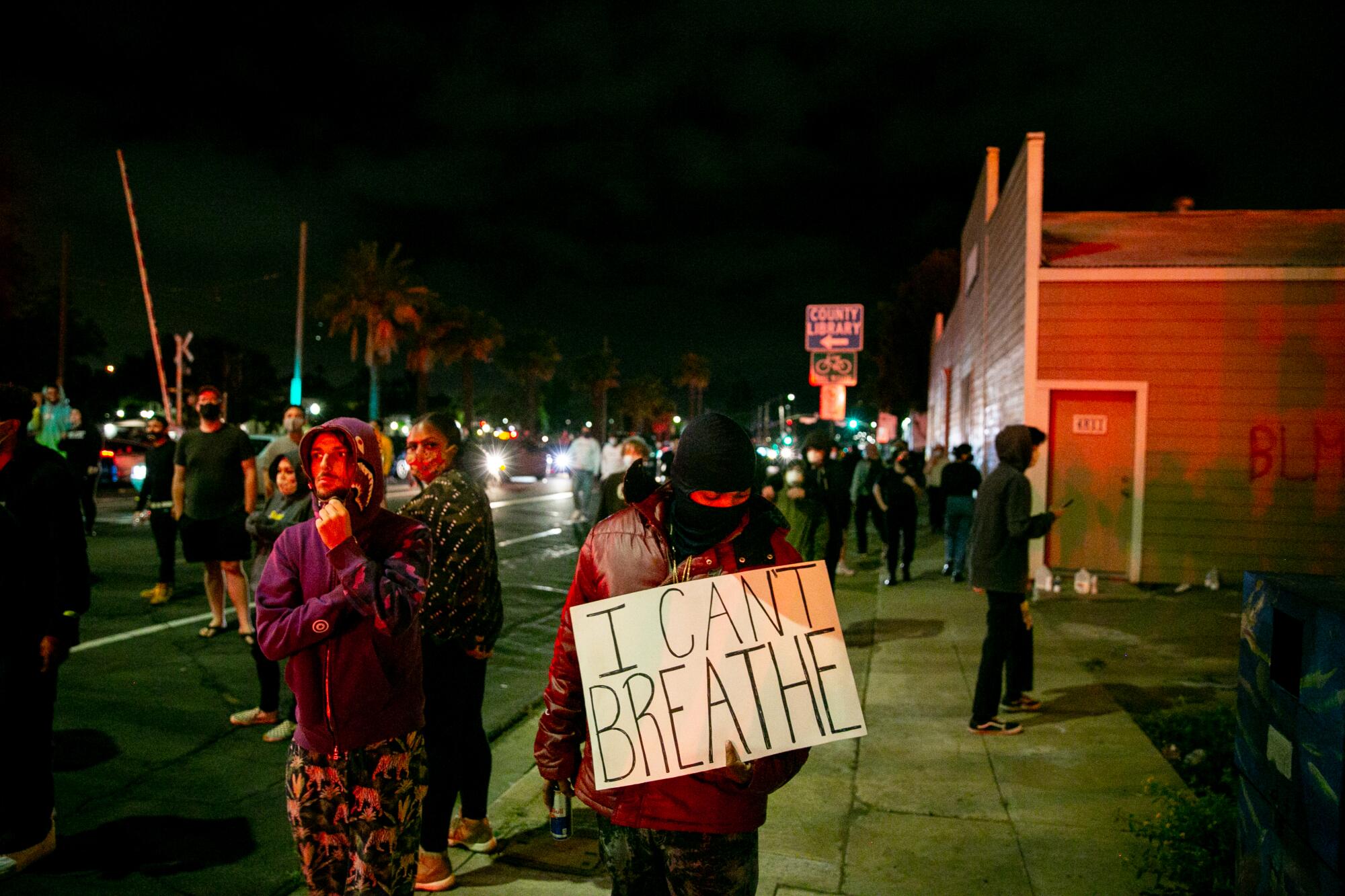 Protesters demonstrate as a Chase bank is burned to the ground by looters on May 30, 2020 in La Mesa, California.