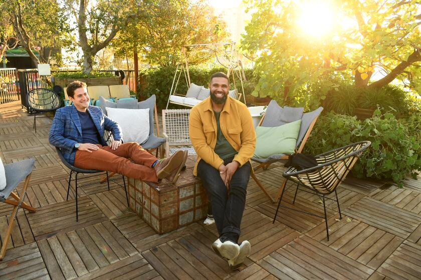 HOLLYWOOD, CALIFORNIA NOVEMBER 24 11, 2020-Co-founders Joe Green, left, and Prophet Walker stand on the rooftop garden at the Treehouse, a co-living apartment building in Hollywood. (Los Angeles Times/Wally Skalij)