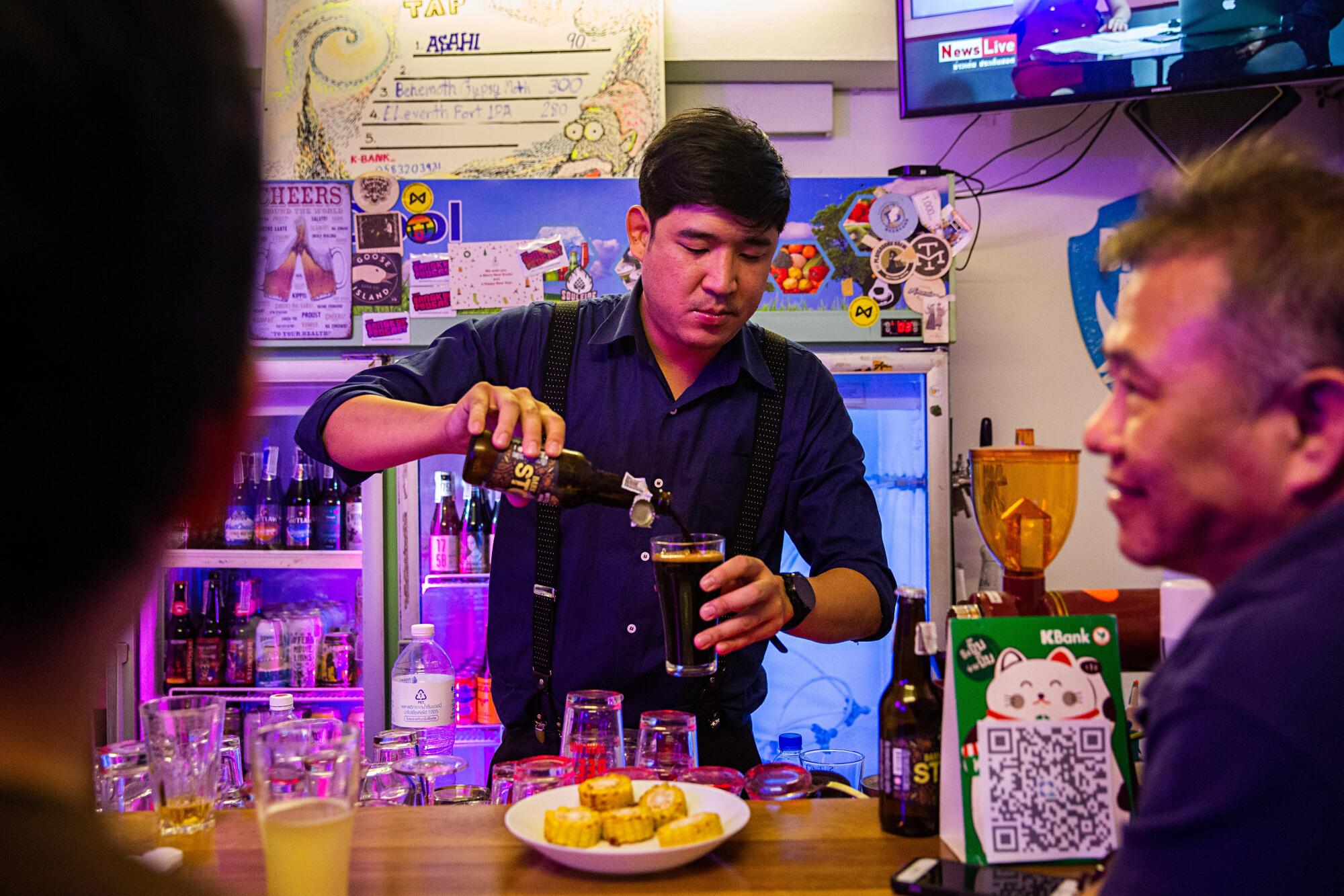 Taopiphop Limjittrakorn, serves beer in his bar, the Taopiphop Bar Project, a craft beer bar in Bangkok.