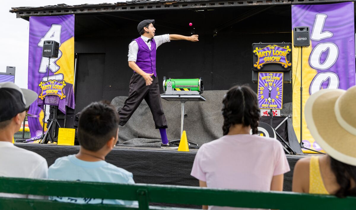 Magician Arty Loon puts on an enthusiastic show for kids at the Original Lobster Festival held in Fountain Valley.