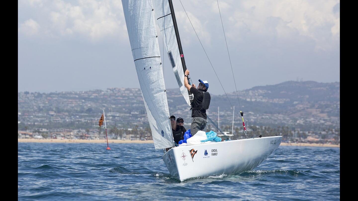 Team New Zealand skippered by George Anyon makes an adjustment to a sail during the Youth Worlds Match Racing Championships on Thursday, August 3.