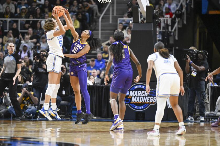 UCLA center Lauren Betts' shot is blocked by LSU forward Angel Reese during a Sweet 16 game in Albany, N.Y., on March 30