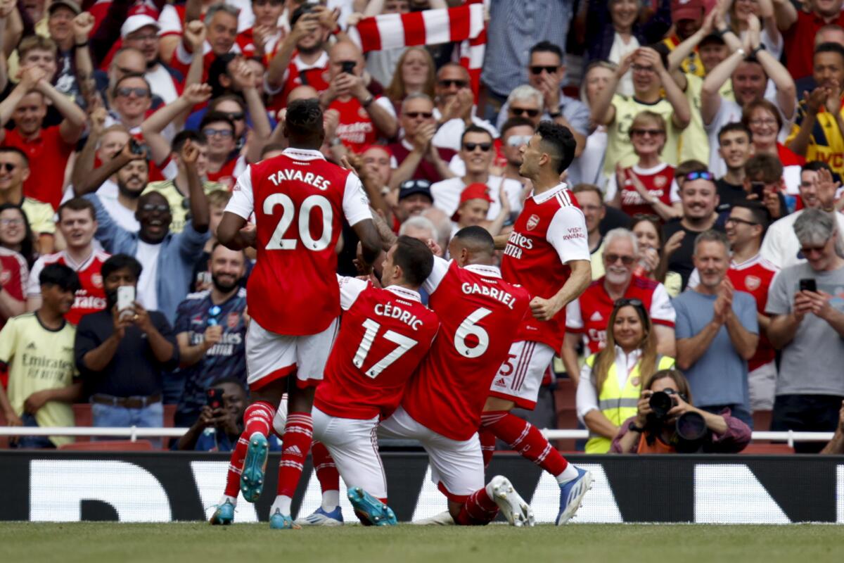 Arsenal's Gabriel Magalhaes, shirt number 6, celebrates scoring his side's fourth goal during the English Premier League soccer match between Arsenal and Everton at the Emirates Stadium in London, Sunday, May 22, 2022.