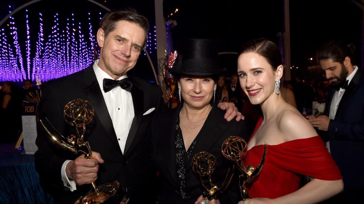 Amy Sherman-Palladino, center, is flanked by Daniel Palladino and Rachel Brosnahan of "The Marvelous Mrs. Maisel" at the 70th Emmy Awards Governors Ball.