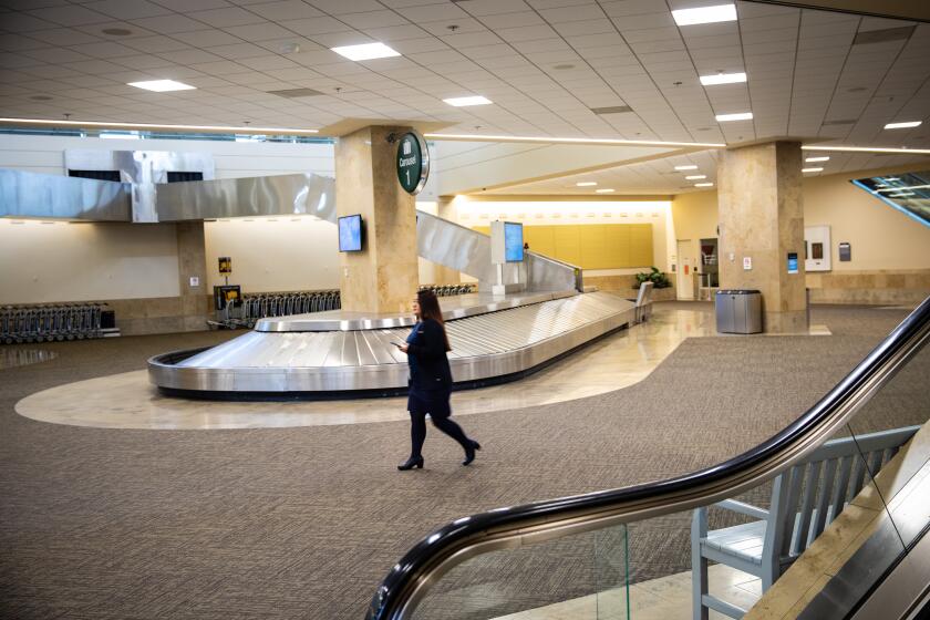 SANTA ANA, CA --MARCH 24, 2020 -An empty baggage claim area in John Wayne Airport, in Santa Ana, CA, March 24, 2020. Airlines are asking the U.S. government for a $50 billion bailout, in response to the collapse of their industry because of coronavirus. (Jay L. Clendenin / Los Angeles Times)
