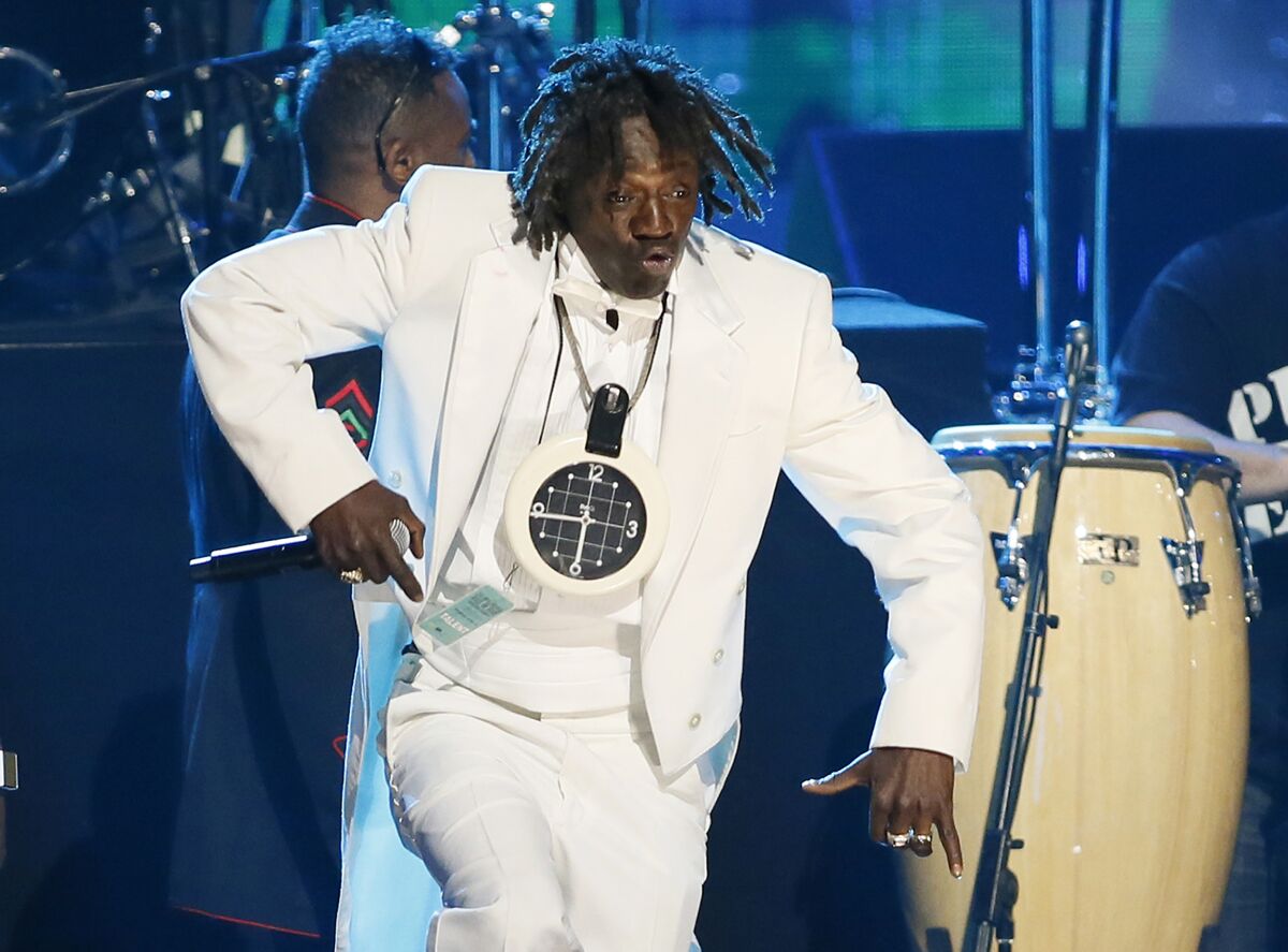 FILE - Flavor Flav of Public Enemy performs during the band's induction at the Rock and Roll Hall of Fame Induction Ceremony at the Nokia Theatre in Los Angeles on April 18, 2013. Attorneys for entertainer Flavor Flav said Wednesday, Dec. 8, 2021, he's working to stay sober following the dismissal of a misdemeanor domestic violence charge stemming from a scuffle with his girlfriend at home in suburban Las Vegas. (Photo by Danny Moloshok/Invision/AP, File)