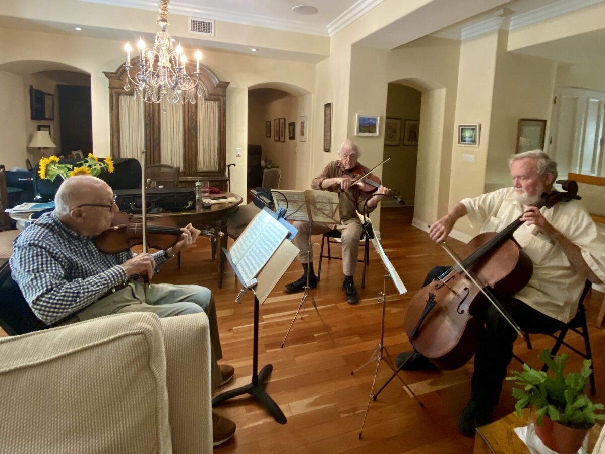 Martin Nass, Jack Clausen and Willis Frisch (from left) gather at Nass’ condominium in La Jolla to play chamber music.