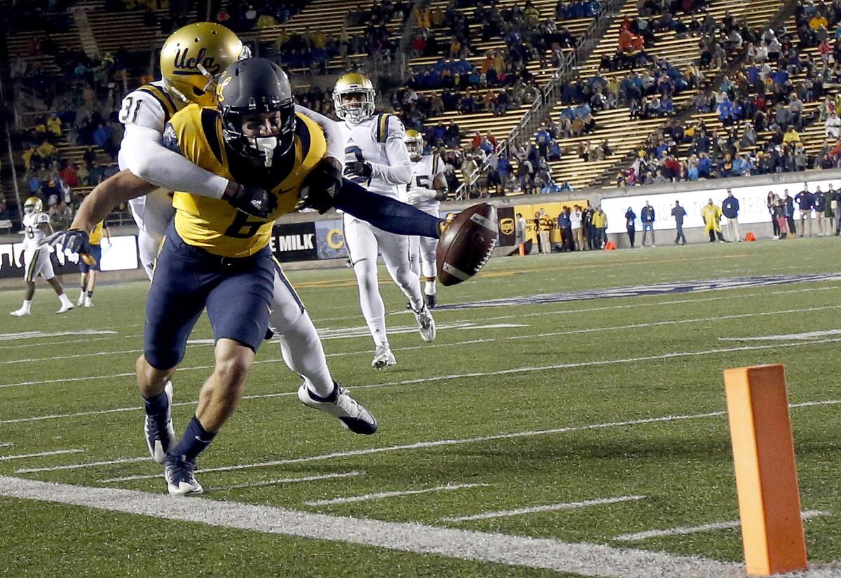 California wide receiver Chad Hansen (6) tries to dive for the end zone as he is tackled by UCLA defensive back Colin Samuel (31) during the second half.