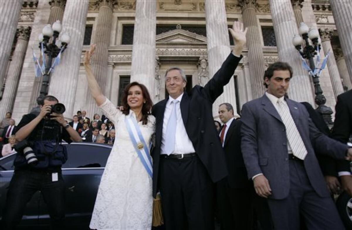 FILE - In this Dec. 10, 2007 file photo, Argentina's new president Cristina Fernandez, left, and her husband, Argentina's departing President Nestor Kirchner, wave after Fernandez was sworn in at the National Congress in Buenos Aires, Argentina. According to state television in Argentina, Nestor Kirchner died on Wednesday Oct. 27, 2010 of a heart attack at age 60. (AP Photo/Jorge Saenz, File)