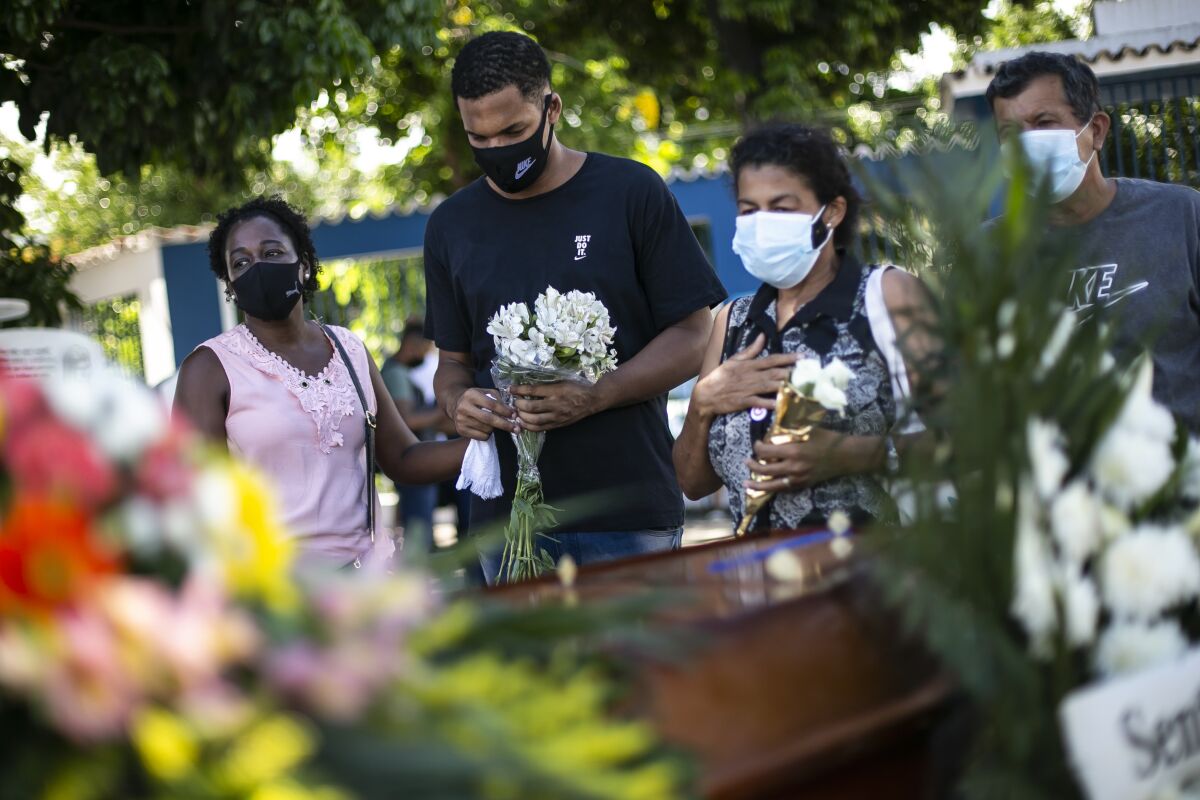 Relatives attend the burial of COVID-19 victim in Brazil