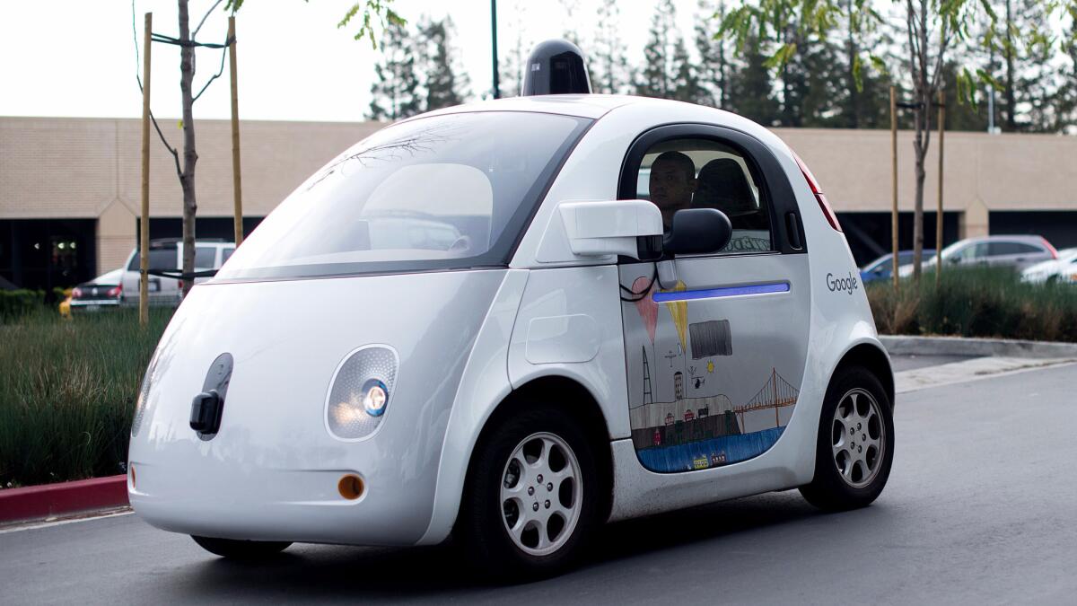 Your transport of the future? A driverless Google pod car tools along a roadway at the company's Mountain View, Calif., headquarters.