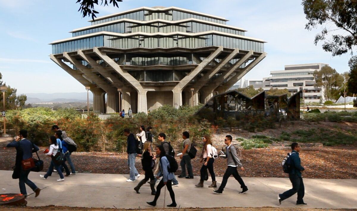 UCSD students walk by the Geisel Library in the heart of campus in this 2011 photo.