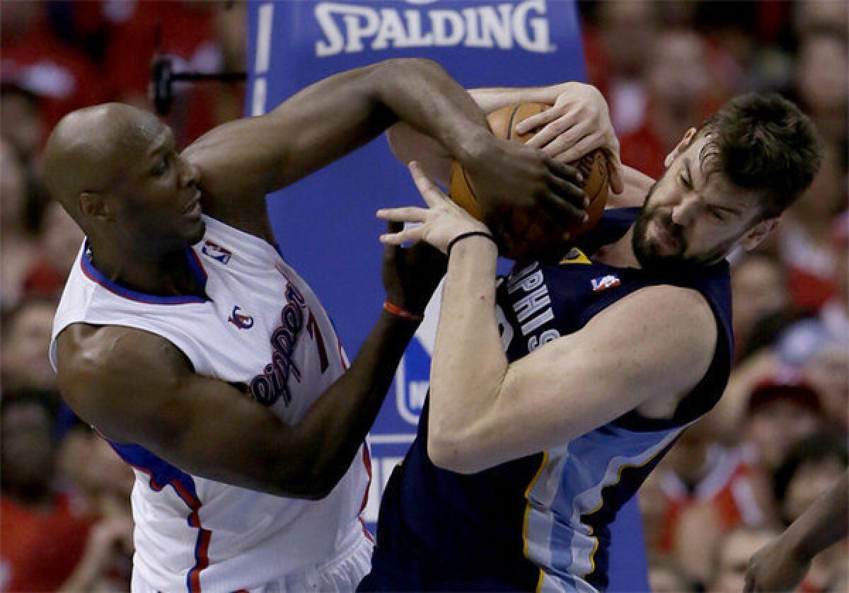 Clippers forward Lamar Odom and Marc Gasol battle for the ball.