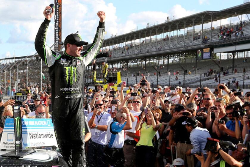 NASCAR Nationwide driver Kyle Busch celebrates in Victory Lane at Indianapolis Motor Speedway on Saturday after winning the Indiana 250.