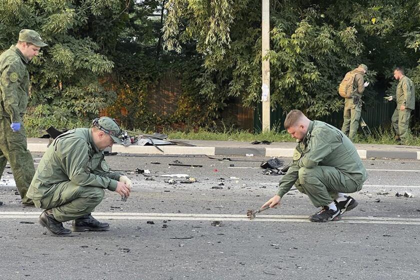 Russian investigators at the scene of a car explosion outside Moscow on Sunday.