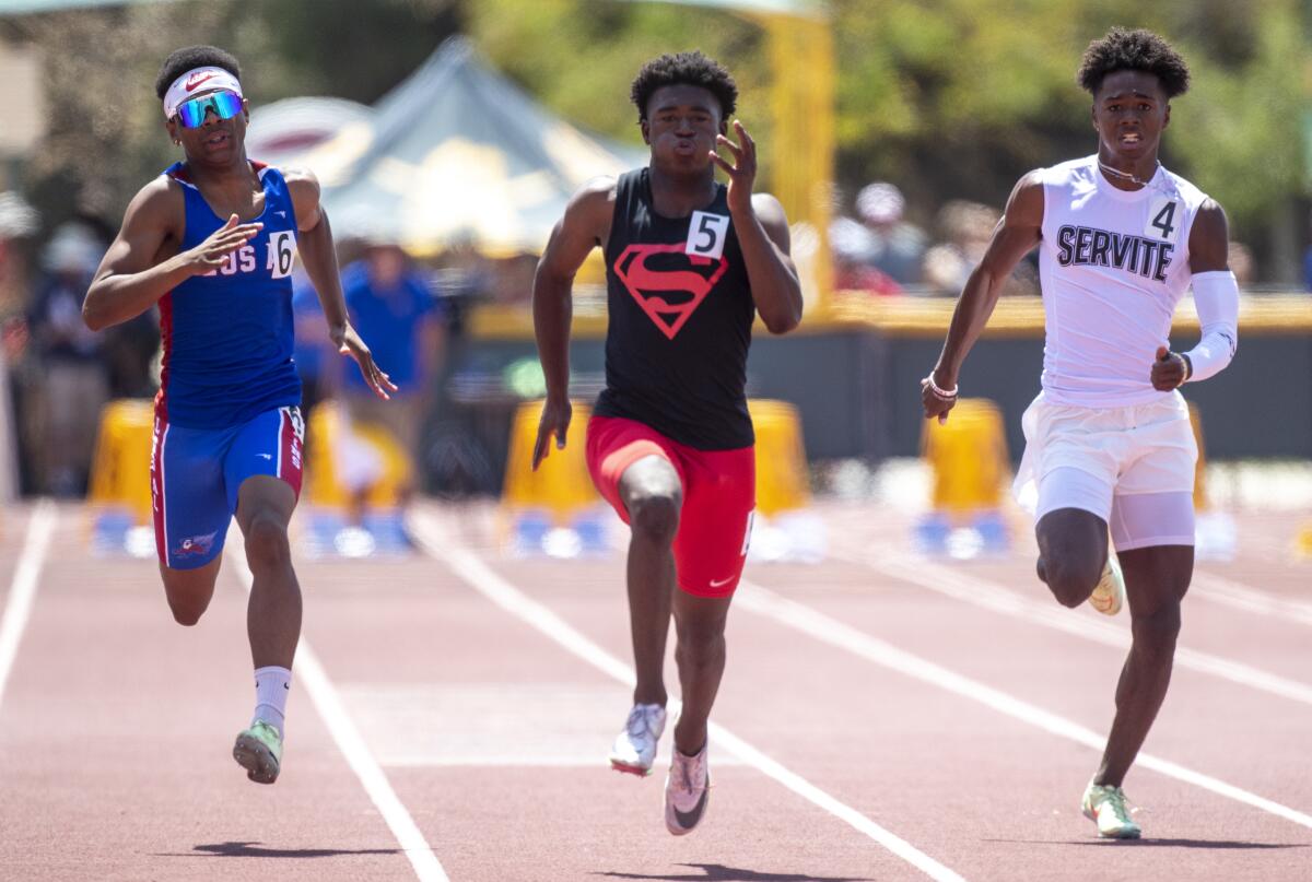 Moorpark, CA - May 21: Rodrick Pleasant of Gardena Serra High, center, is out in front to win the 100 meters.