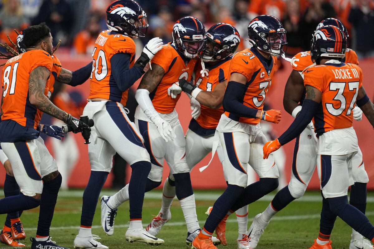 Denver Broncos cornerback Pat Surtain II (2) celebrates his interception with teammates during the second half of an NFL football game against the Los Angeles Chargers, Sunday, Nov. 28, 2021, in Denver. (AP Photo/Jack Dempsey)