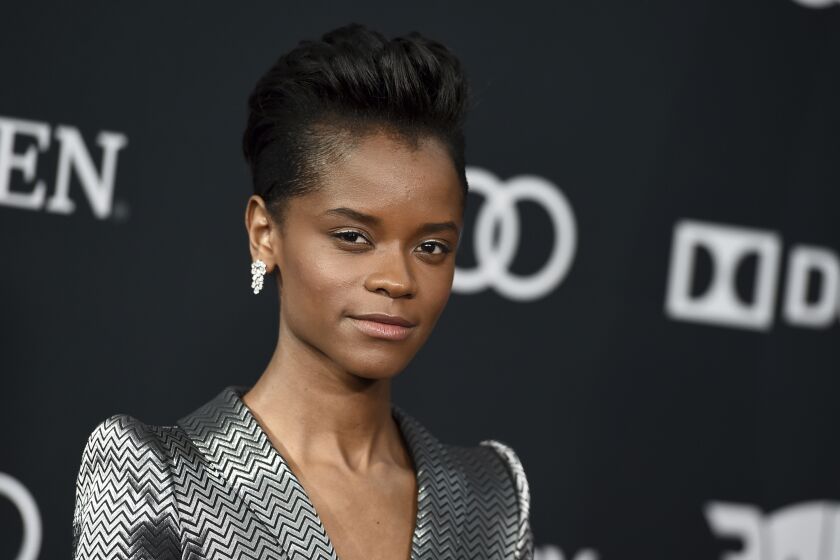 Letitia Wright wearing a striped silver suit