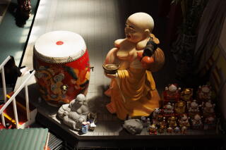 A buddha statue and other items inside the Asian Garden Mall.
