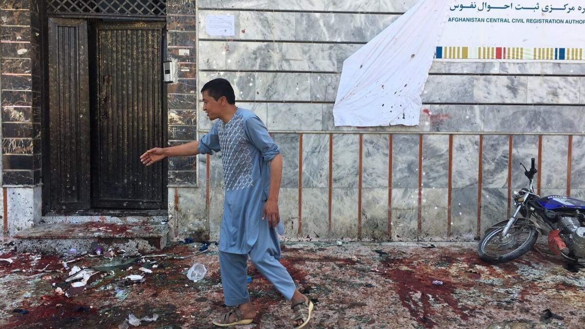 An Afghan man outside a voter registration center in Kabul after the suicide bombing.