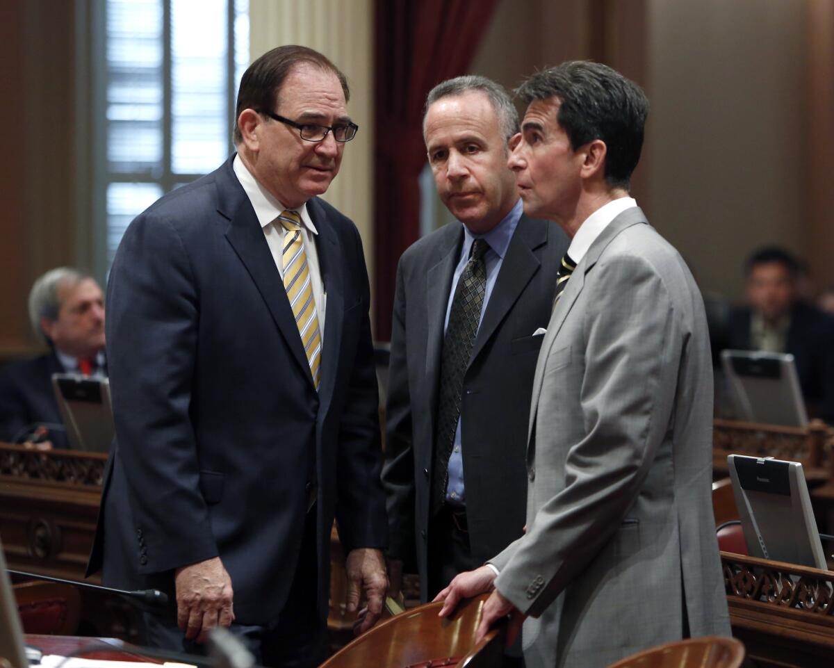 Senate Minority Leader Bob Huff (R-Diamond Bar), left, huddles with Senate President Pro Tem Darrell Steinberg (D-Sacramento), center, and Sen. Mark Leno ( D-San Francisco) last month. On Monday, Huff introduced resolutions to suspend two senators who are facing criminal charges, but Steinberg led a vote to have both measures sent to committee.