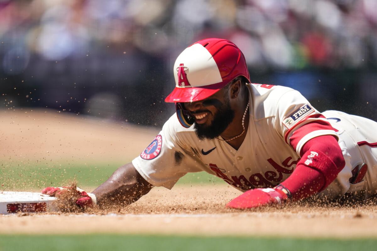 Angels' Luis Rengifo dives back to first base during a 3-2 loss to the Seattle Mariners on Sunday.