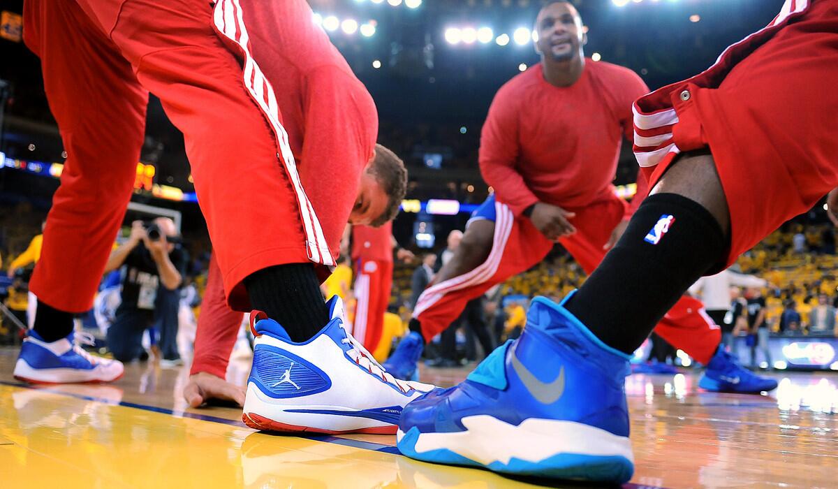 Clippers players sport black socks in a show of solidarity before Game 4 of their playoff series against the Golden State Warriors.