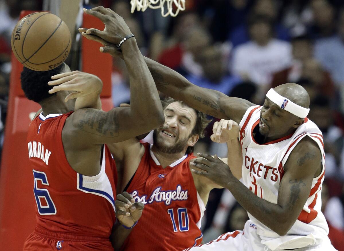 Clippers center DeAndre Jordan (6) and forward Spencer Hawes (10) battle Rockets guard Jason Terry for a rebound in the second half.