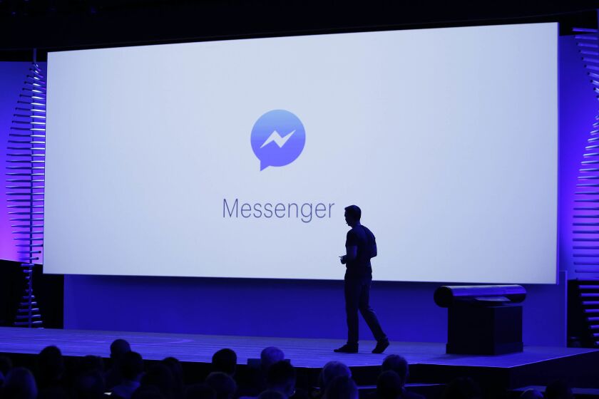 FILE - In this Tuesday, April 12, 2016, file photo, new features of Messenger are displayed during the keynote address at the F8 Facebook Developer Conference in San Francisco. Facebook has squeezed just about as many ads into its main platform as it can. Any more and users might start to complain. Now, ads are moving on to Messenger, and WhatsApp may not be too far behind. (AP Photo/Eric Risberg, File)