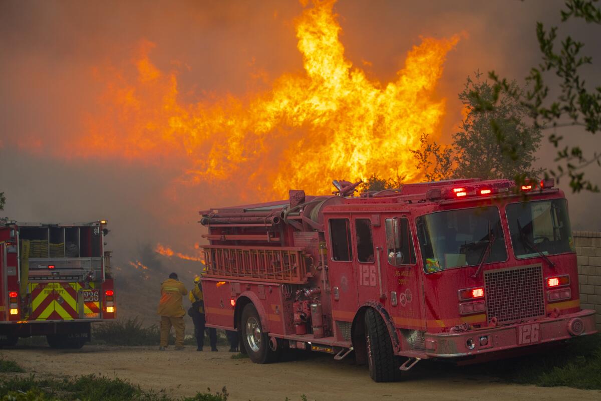 A firetruck parked near a wildfire