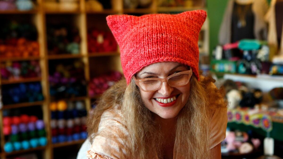 Little Knittery owner Kat Coyle wears one of her iconic pussy hats.  