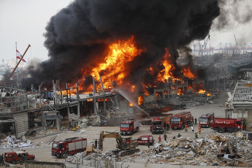 Fire burns in the port in Beirut, Lebanon, Thursday, Sept. 10. 2020. A huge fire broke out Thursday at the Port of Beirut, triggering panic among residents traumatized by last month's massive explosion that killed and injured thousands of people. (AP Photo/Hussein Malla)