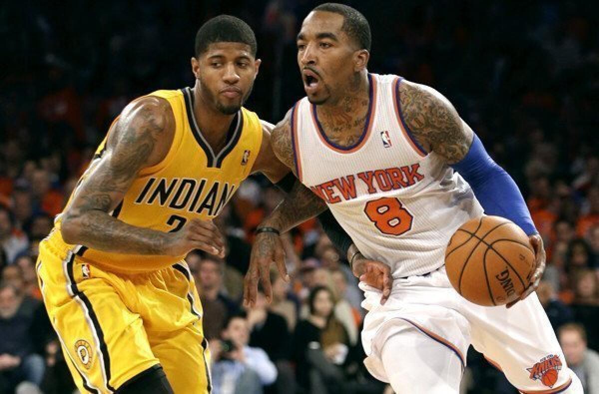Knicks guard J.R. Smith drives past Pacers forward Paul George during a playoff game last season.