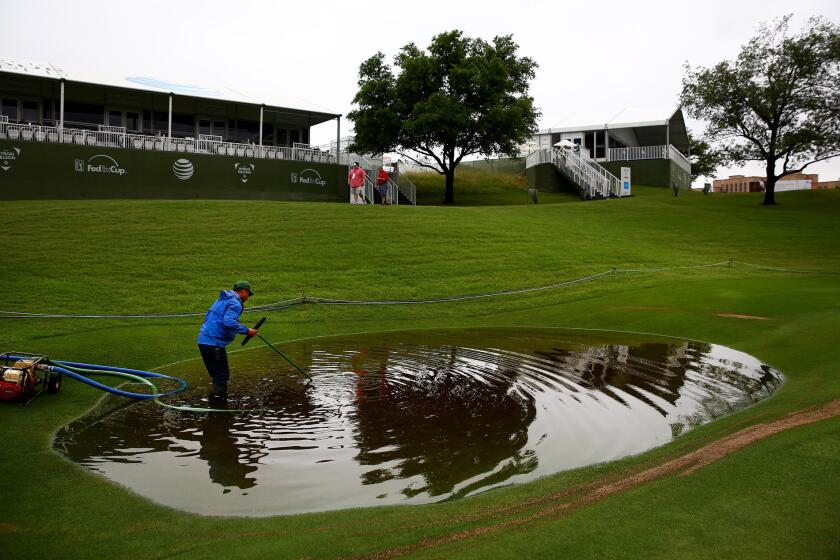 A member of the grounds crew works May 29 to remove standing water on the 17th hole at the TPC Four Seasons Las Colinas Golf Course after heavy rains delayed the second round of the Byron Nelson Championship in Irving, Texas.