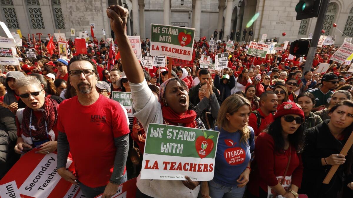 Dolly Sanders, center, a teacher at Grant Elementary School, joins thousands of other educators with United Teachers Los Angeles at a rally on the fifth day of the teachers' strike in Grand Park.