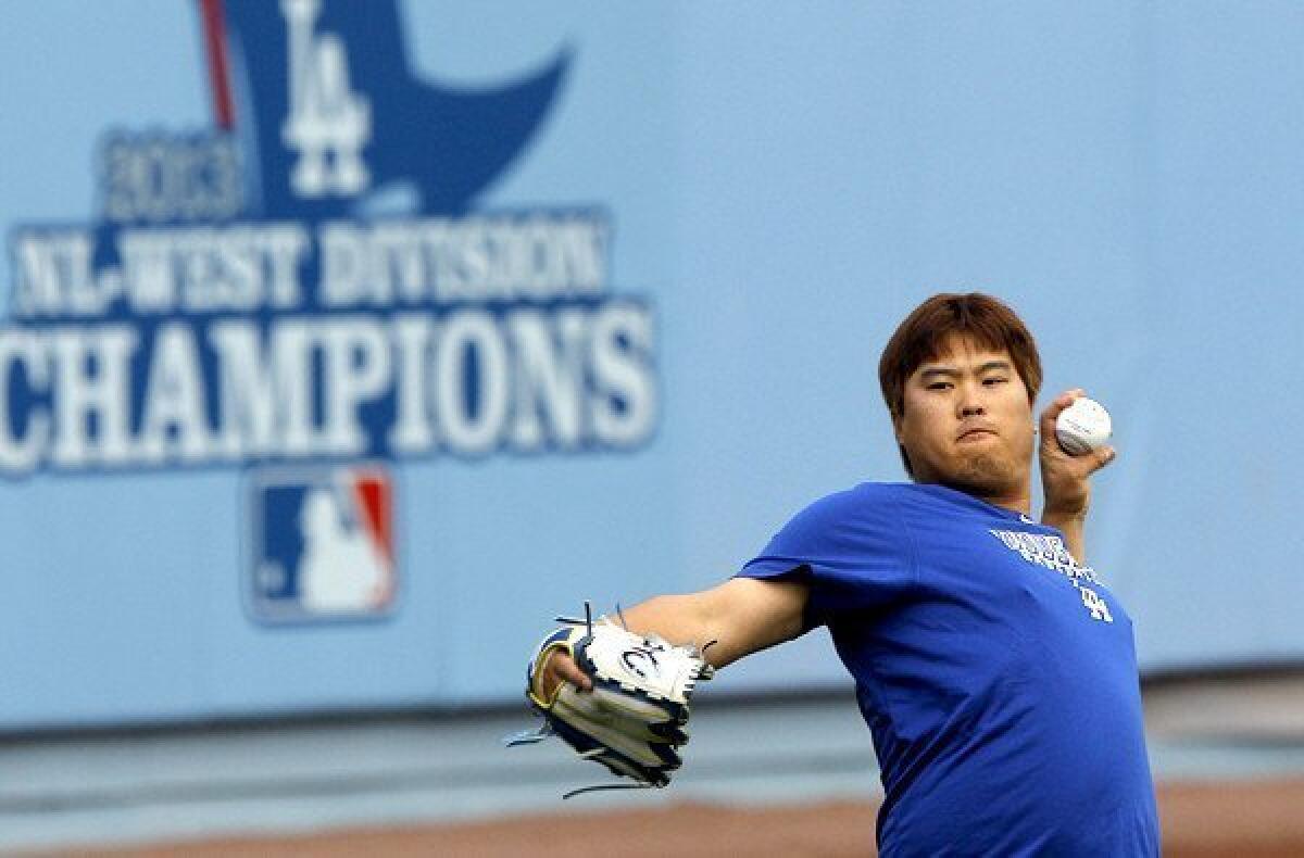 Dodgers starting pitcher Hyun-Jin Ryu goes through a workout at Dodger Stadium on Sunday in preparation for his start in Game 3 of the NLCS on Monday.