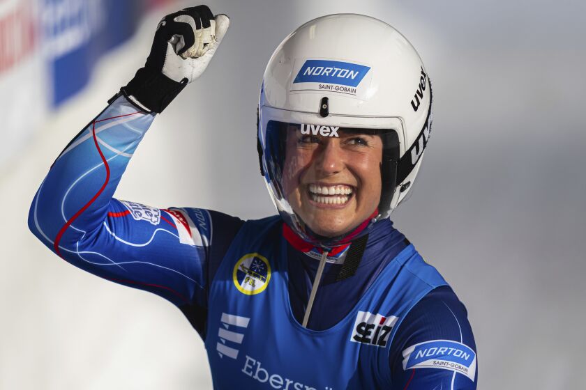 Emily Sweeney of the United States celebrates during the women's race at the Luge World Cup in Igls near Innsbruck, Austria, Saturday, Dec. 3, 2022. (AP Photo/Florian Schroetter)