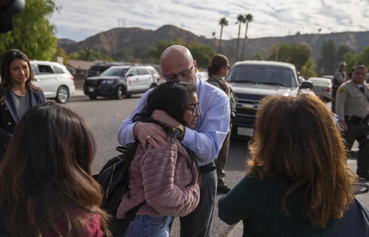 Students are reunited with family outside Saugus High School.
