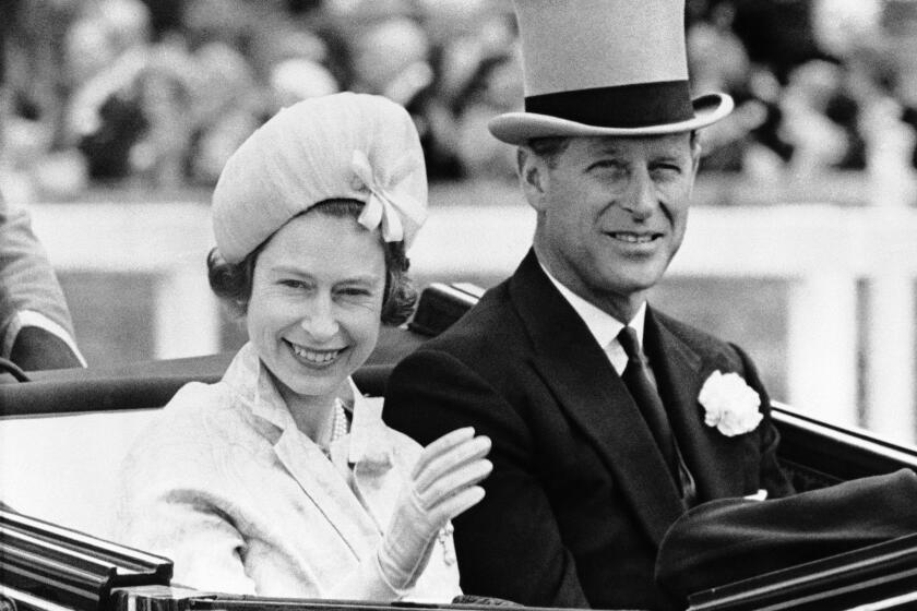 FILE - In this June 19, 1962 file photo, Britain's Prince Philip and his wife Queen Elizabeth II arrive at Royal Ascot race meeting, England. Buckingham Palace says Prince Philip, husband of Queen Elizabeth II, has died aged 99. Buckingham Palace says Prince Philip, husband of Queen Elizabeth II, has died aged 99. (AP Photo/File)