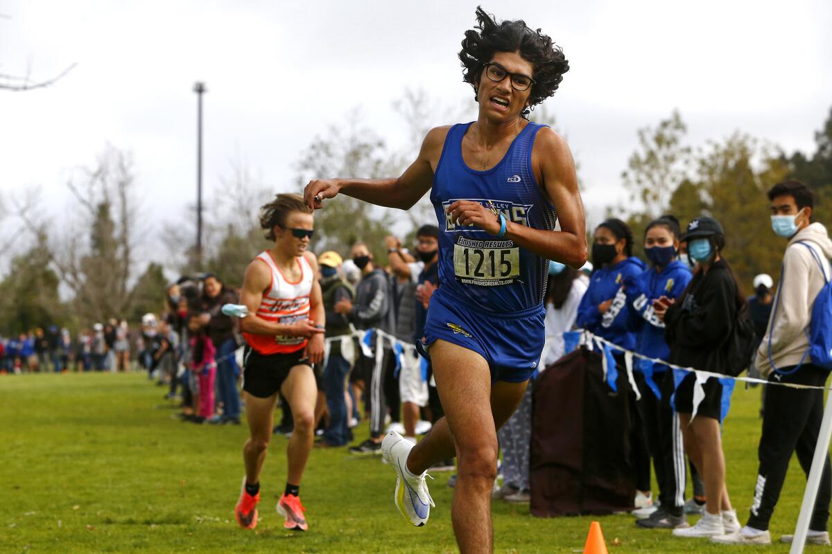 Fountain Valley's Dezi Hernandez, right, finishes first for the Wave League boys against Huntington Beach's Nolan Walt.